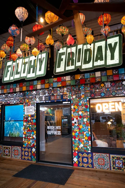 The shop's tiled entrance under a Filthy Friday sign and hanging lanterns