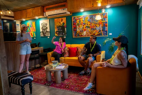Visitors relaxing on yellow sofas in the shop's lounge, surrounded by local art