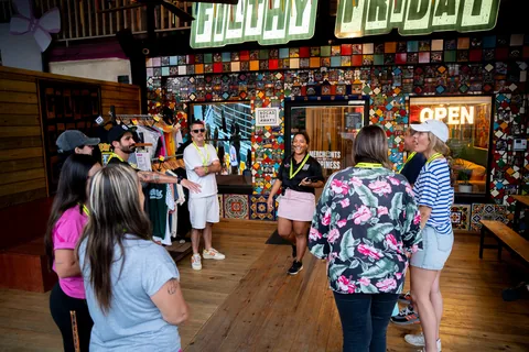 A walking tour group gathered inside the Too Much Tours shop before setting off