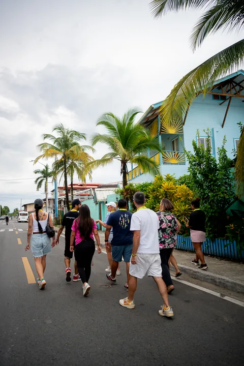 The walking tour group strolling down a palm-lined street in Bocas Town