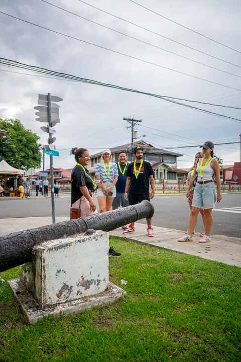 The walking tour group next to an old cannon in a small park in Bocas Town