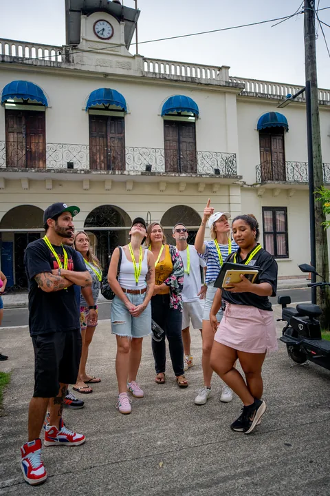 A guide talking to the walking tour group in front of a historic building with a clock tower