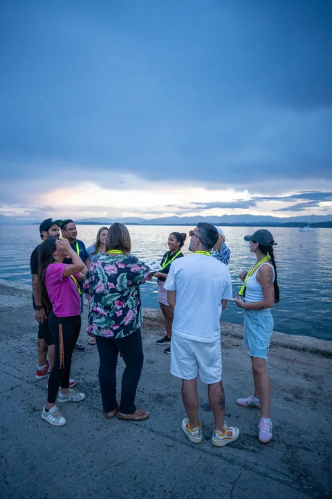 The walking tour group on the waterfront at sunset