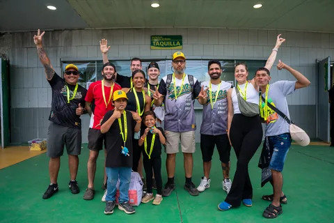 A smiling group with tour lanyards outside the ticket office at Calvin Byron Stadium