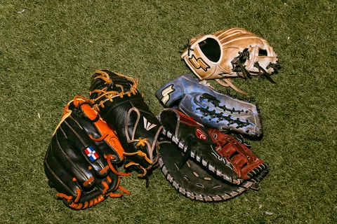Baseball gloves lying on the grass